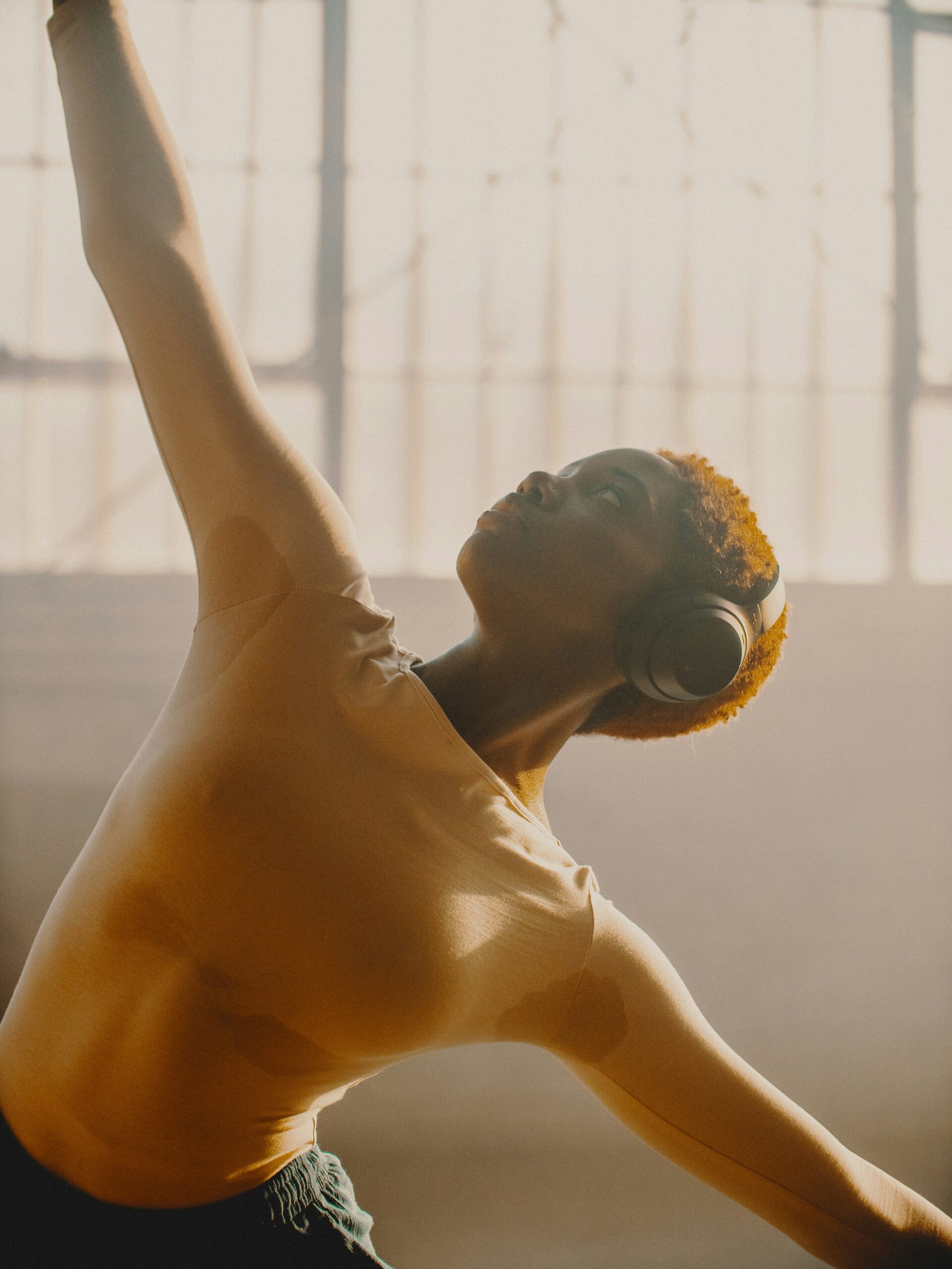 Sweaty woman listening to workout playlists from The Motion Reset during her workout