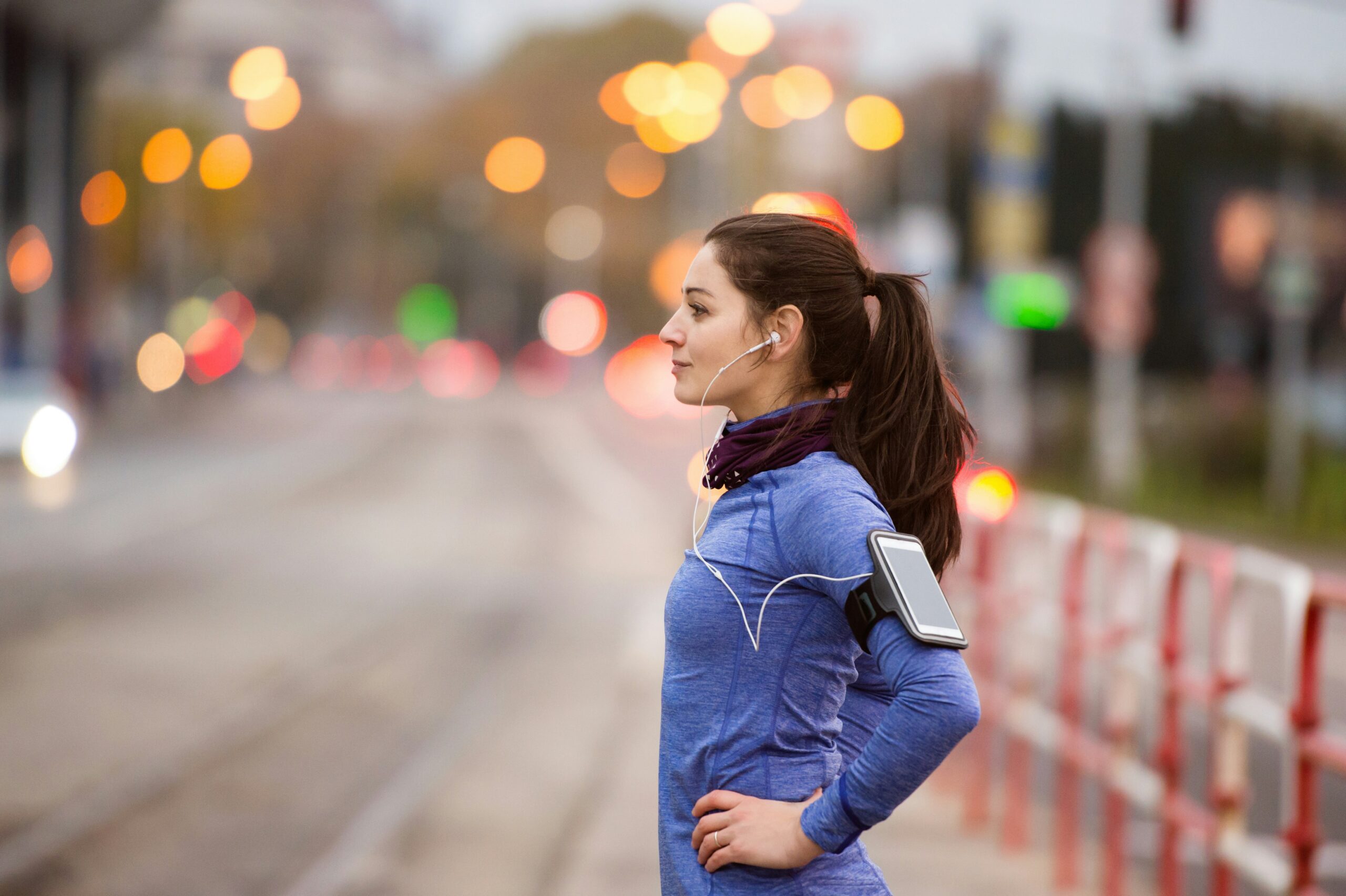 Woman preparing for luteal phase cardio workout on jogging path.