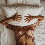 A woman frustrated by perimenopause sleep problems.