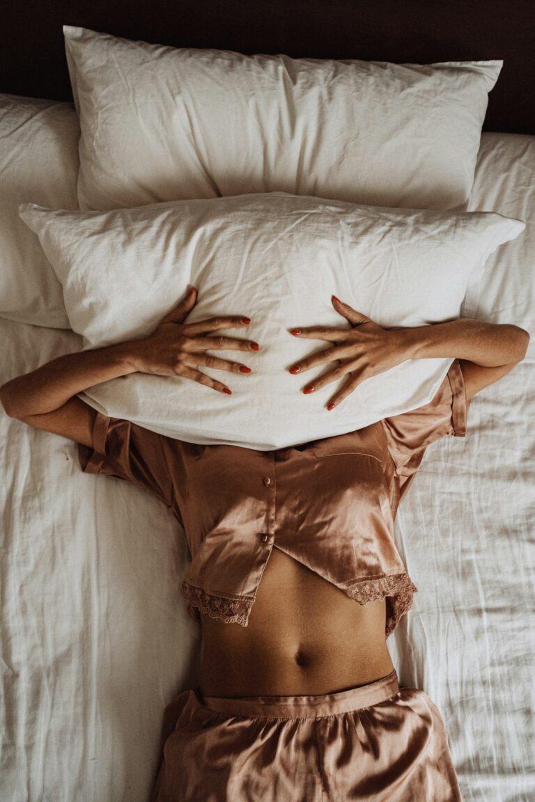 A woman frustrated by perimenopause sleep problems.