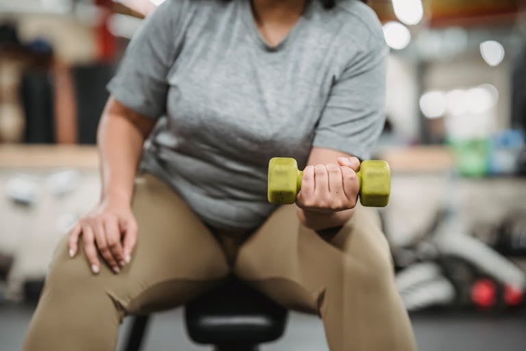 Woman in perimenopause strength training with dumbbells